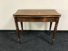 A late 19th century mahogany turnover top tea table on turned legs