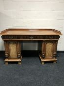 A late nineteenth century walnut twin pedestal desk fitted with three drawers