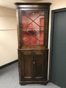 An antique pine corner cupboard