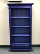 A blue painted pine open shelves with drawer beneath.