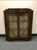 A 20th century double door walnut display cabinet