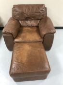 A brown leather armchair and footstool