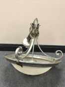 A decorative metal ceiling light with opaque glass shade