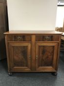 A late 19th century double door sideboard on bun feet
