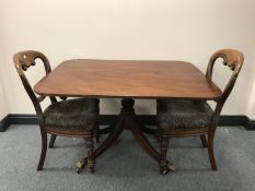 A Victorian mahogany tilt-top breakfast table together with two balloon back chairs