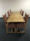 A blond oak refectory extending dining table together with six chairs upholstered in a red striped