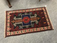 A Baluchi rug on red ground