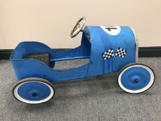 A tin plate pedal car in the form of a vintage race car