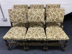 A set of six oak dining chairs upholstered in a floral fabric