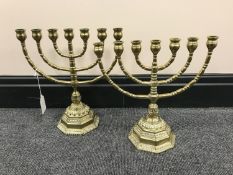 A pair of decorative brass menorahs,