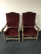 A pair of heavily carved oak scroll arm armchairs