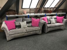 A contemporary three seater settee and matching two seater settee with assorted cushions