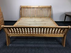 A contemporary plantation pine 6' rail bed frame
