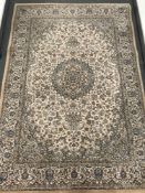 A contemporary floral rug on beige ground