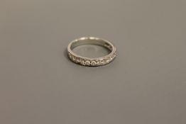 An 18ct white gold diamond half eternity ring,