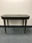 A late 19th century ebonised library table with brass inlay,