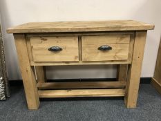 A reclaimed pine two drawer side table