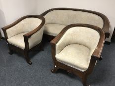 A early 20th century mahogany framed three-piece lounge suite upholstered in a floral fabric