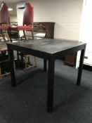 A contemporary black ash square poser table