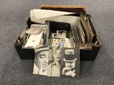 A box of assorted ephemera, poster cards, postcards, greetings card,