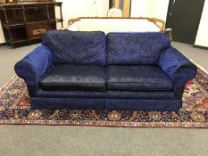 A Delcor three seater settee upholstered in crushed blue velvet encrusted with diamond-effect studs,