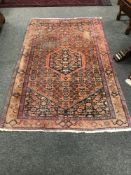 A North West Persian rug on burnt orange ground