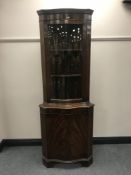A mahogany glaze door corner display cabinet