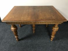 An antique oak extending table on turned legs with six pine extension leaves