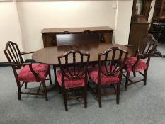An eight piece Regency style dining room suite comprising of serpentine fronted sideboard,