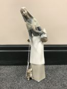 A Lladro figure of a lady with a puppy