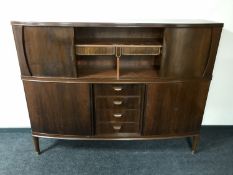 A mid 20th century teak shutter door sideboard