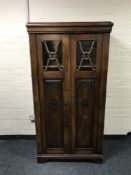A continental carved oak double door cabinet