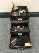 A three drawer desk top miniature chest containing watches, brass ware, match book,