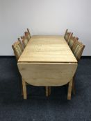 A blond oak extending drop end dining table with leaves,