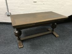 An oak pull out refectory coffee table