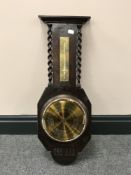 An oak barley twist barometer with brass dial