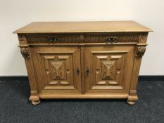 A carved oak double door sideboard
