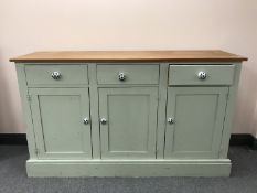 A painted pine triple door sideboard