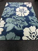 A contemporary floral carpet on blue ground