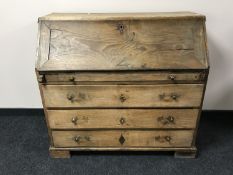 A 19th century continental elm bureau fitted three drawers