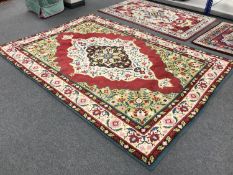 A woollen floral carpet on red ground