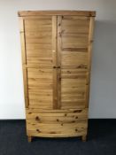 A contemporary plantation pine Seville bow-fronted wardrobe fitted two drawers