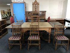 An early 20th century oak extending refectory style dining table, with two leaves,