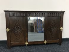 An early 20th century oak mirrored coat rack