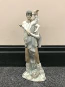 A Lladro figure of a man carrying goat