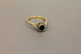 An 18ct gold diamond and sapphire cluster ring CONDITION REPORT: Size O.