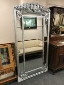 A large contemporary overmantle in silvered frame