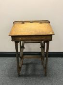 A mid-20th century child's school desk with inkwell