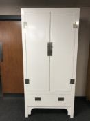 A white lacquered oriental style wardrobe fitted a drawer
