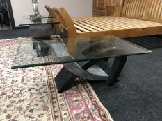A contemporary glass topped coffee table